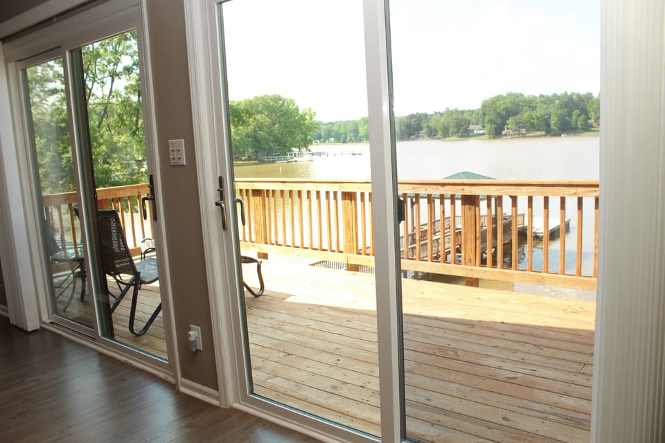 Double sliding doors lead to private deck in master bedroom 