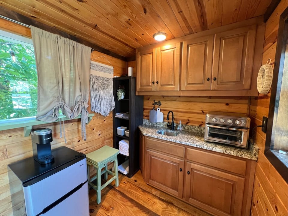A mini-fridge with freezer, space for a pint of ice cream for your your midnight snack!