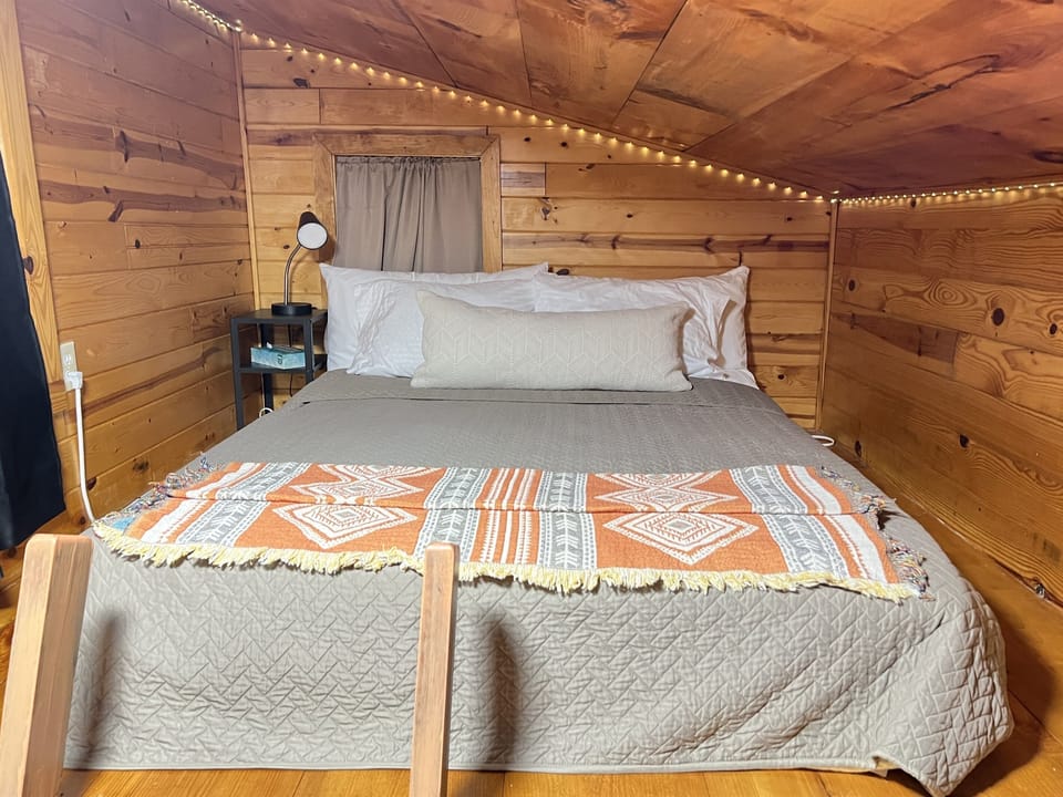 This lofted bedroom provides a cozy atmosphere surrounding you with twinkle lights spanning the perimeter of the loft. A perfect relaxing place to escape the pressures of life and have a restful getaway. Black-out curtains ensure deep long sleep.