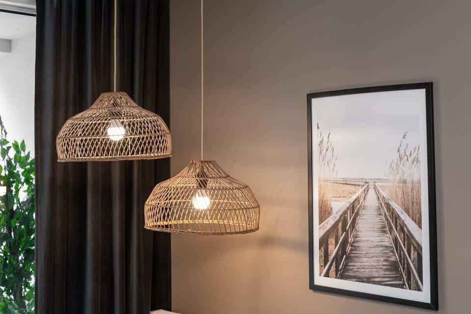 Elegant light fixture over a framed artwork, adding a warm glow to the decor.
