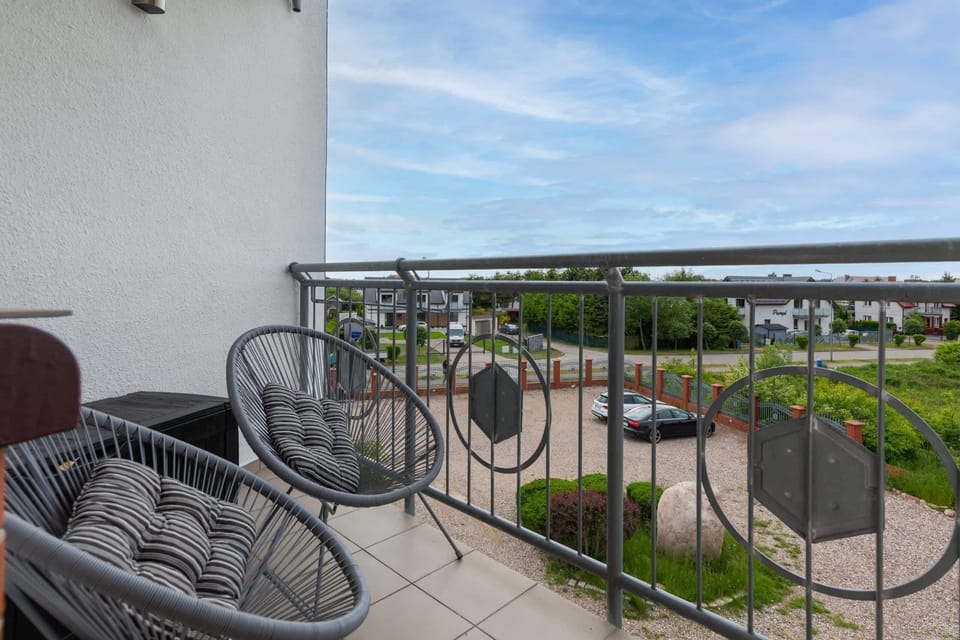 Spacious balcony with outdoor furniture. 