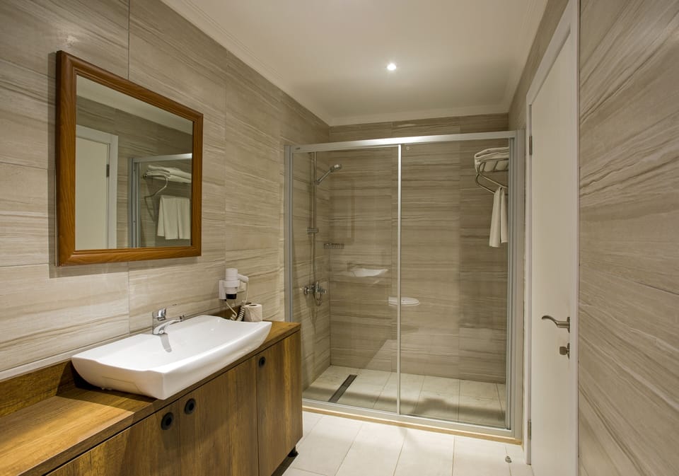 Shower, hair dryer, slippers, towels