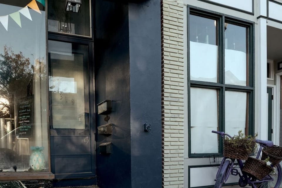 A black street-level door provides the private Main Street entrance to the studio.