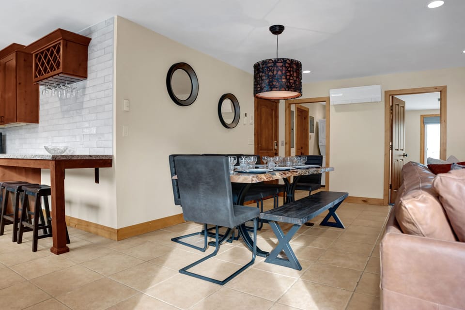 Dining room with solid wood dining room table, dining bench, and floating high back dining chairs