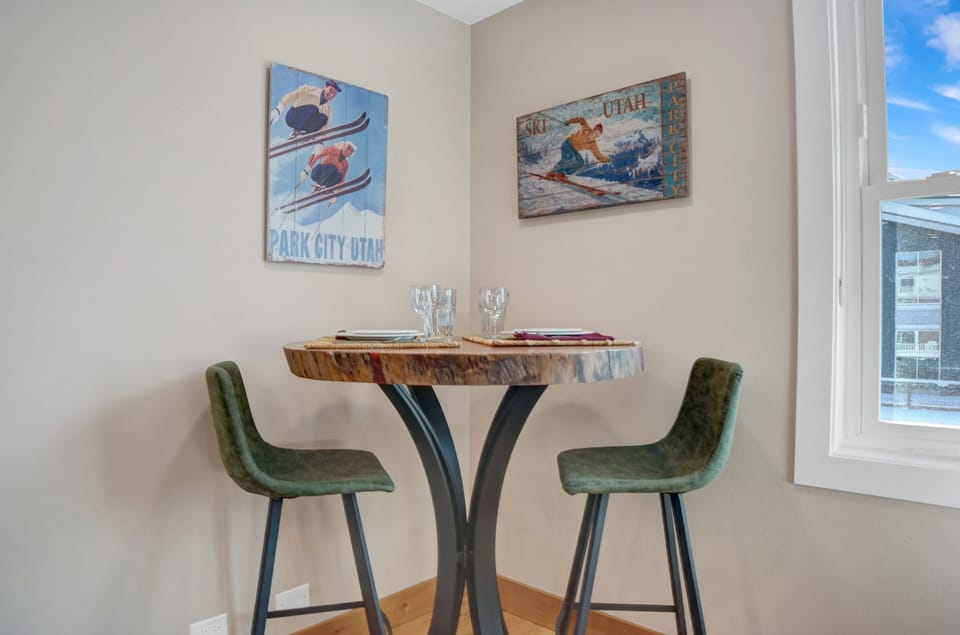 Solid wood bistro table with modern upholstered leather barstools