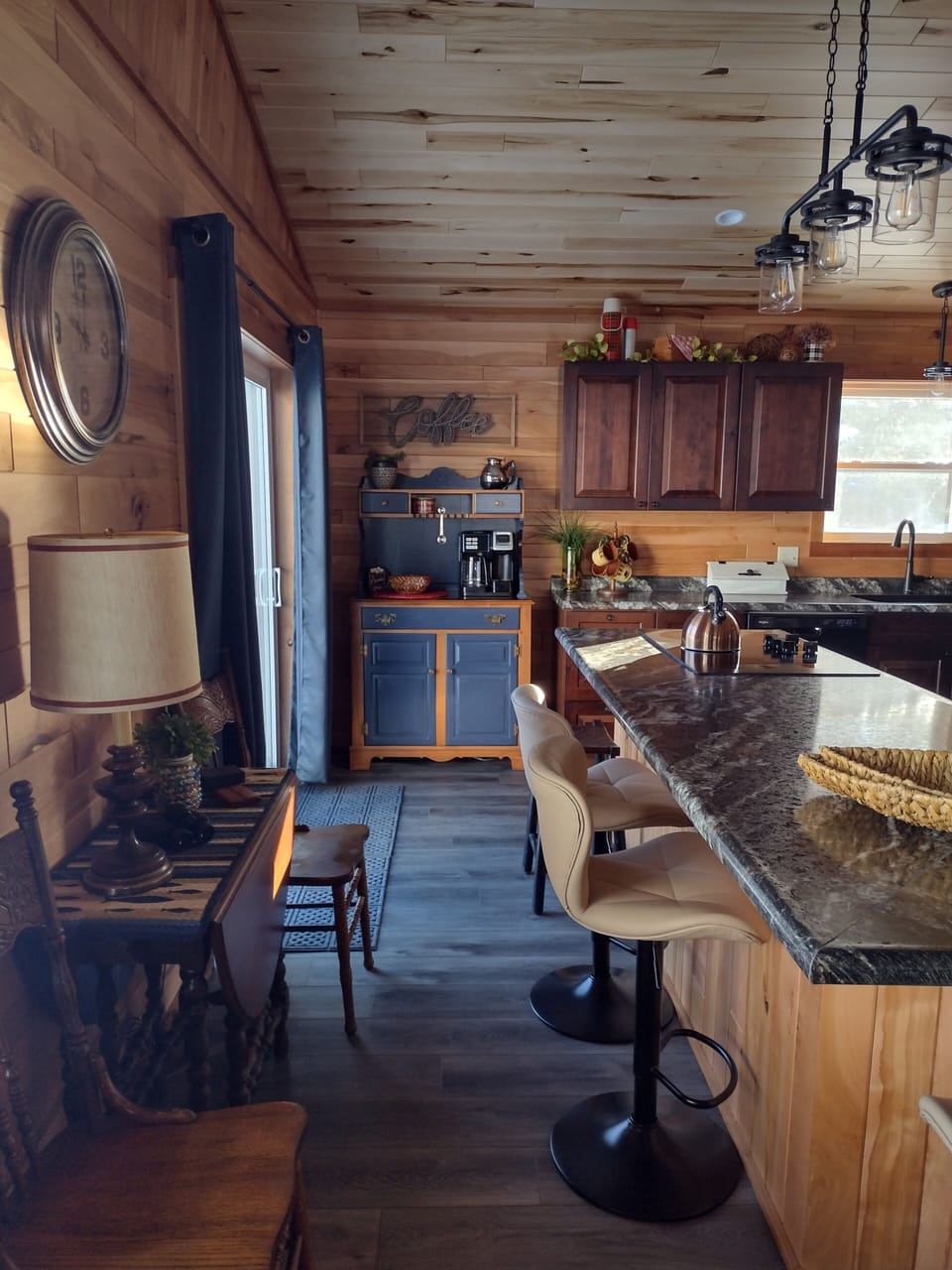 Coffee bar and fold-down side table with  2 chairs opposite island counter