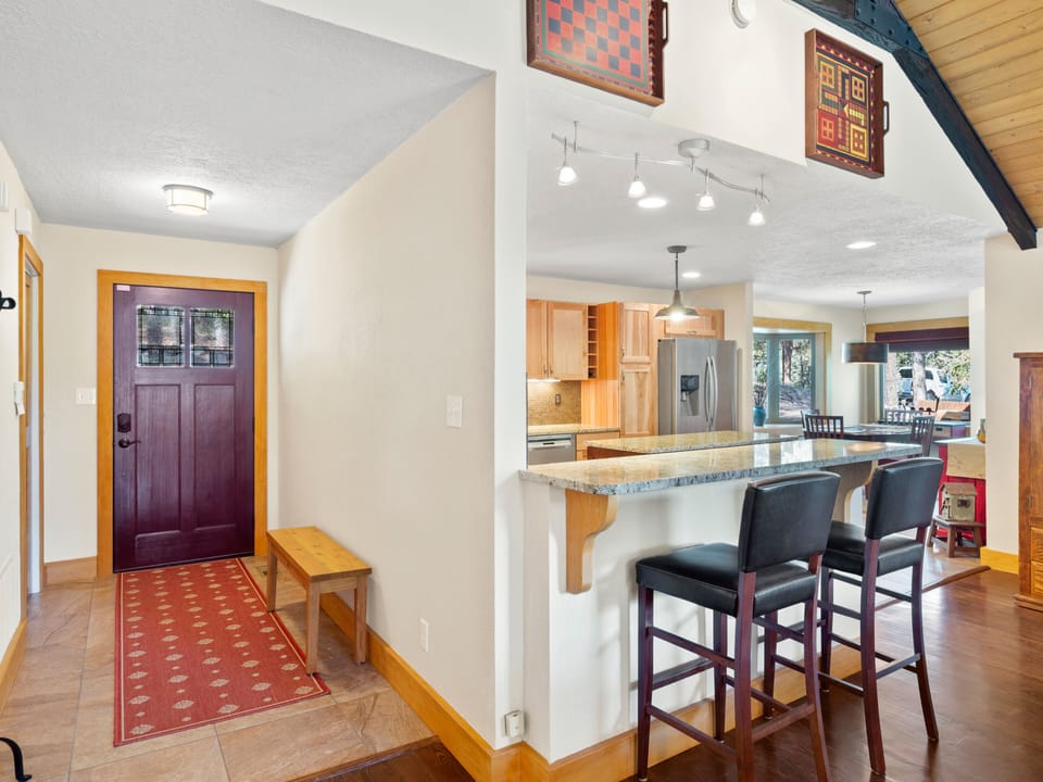 Front door entrance and view of kitchen