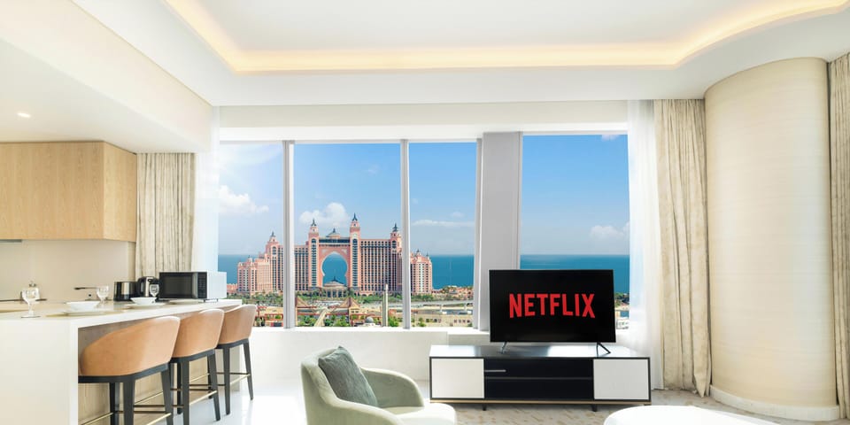 Deluxe Apartment | Living area | 55-inch Smart TV with cable channels, TV, Netflix