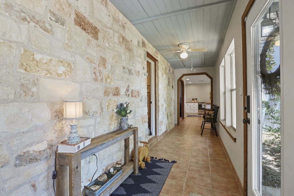 View as you walk down the hallway from the bedrooms. The kitchen is seen at the end of the hallway.