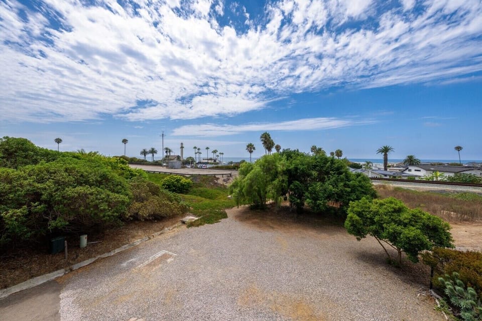 Enjoy coastal views framed by palm trees from the property.