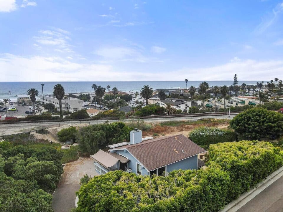 Bird’s-eye view of the home and its beautiful coastal surroundings, just moments from the ocean.