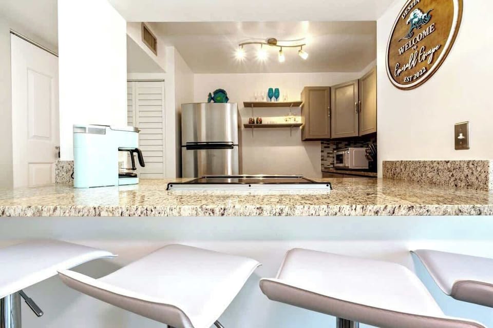 Our kitchen area is an open concept to the living area, with 4 modern style barstools at the breakfast bar for enjoying your meals and time together.