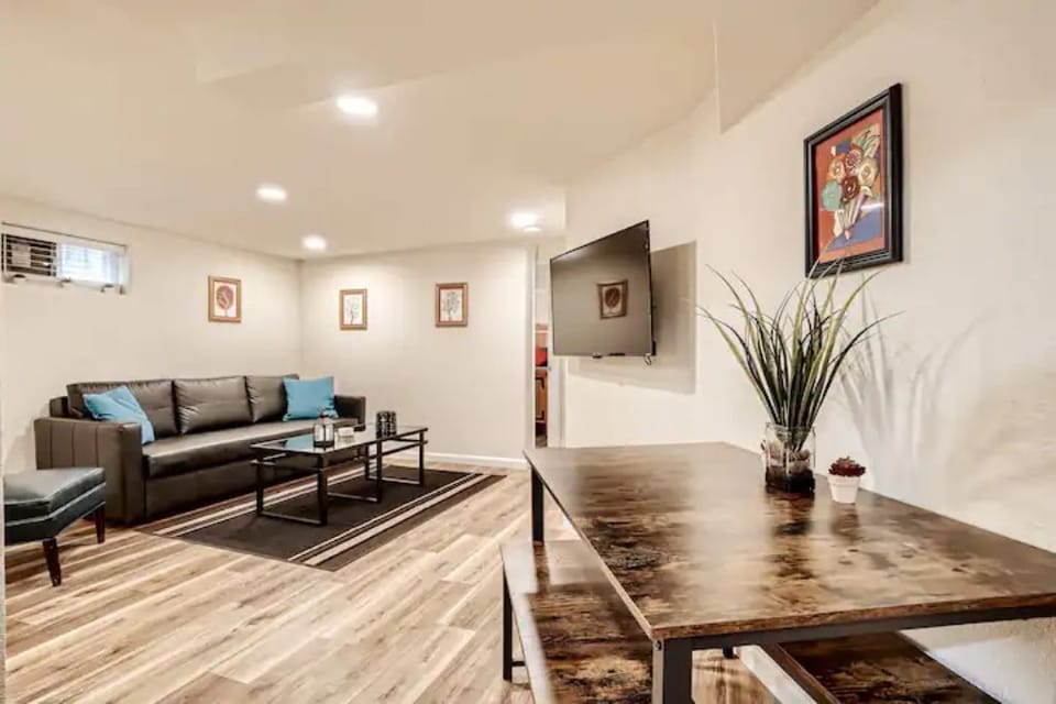dining area and living area with 43-inch UHD Roku Smart TV and full sofa bed.