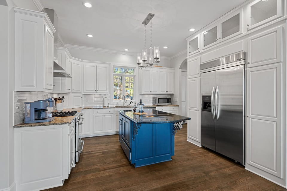 Gourmet kitchen with island and upgraded appliances.