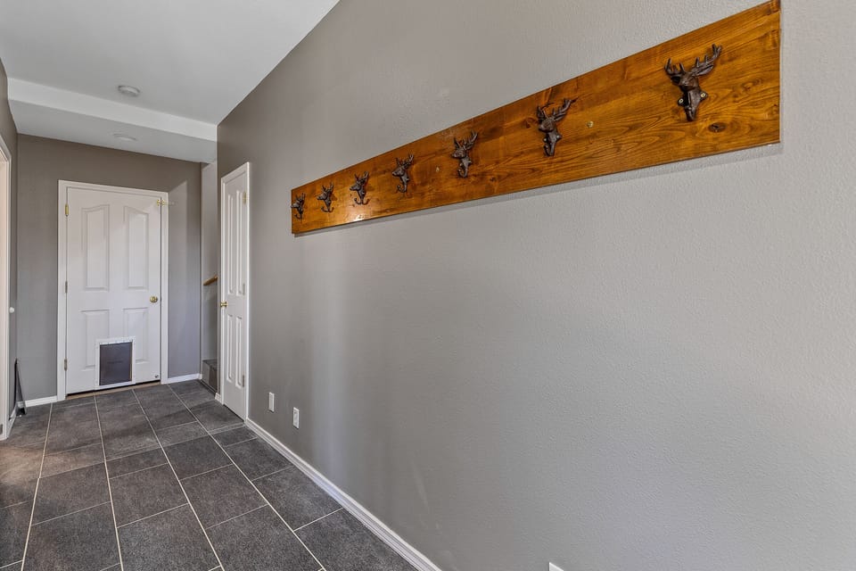 Entering the home from the garage leads immediately to a mud room area to hang jackets and other gear.