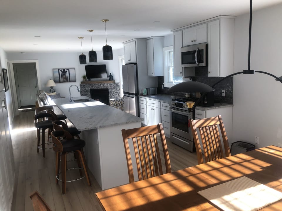 View of the sitting/kitchen/dining rooms taken from the dining room area.
