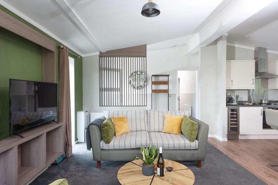 A comfortable sofa, coffee table and TV - Daisy Lodge