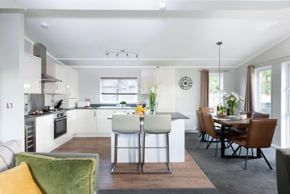 The living area, kitchen, dining table and sofas - Daisy Lodge