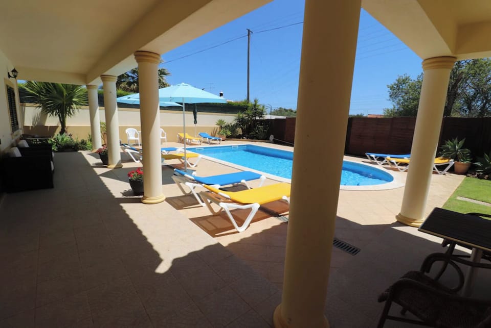 Plenty of shade for hotter days on the veranda by the swimming pool