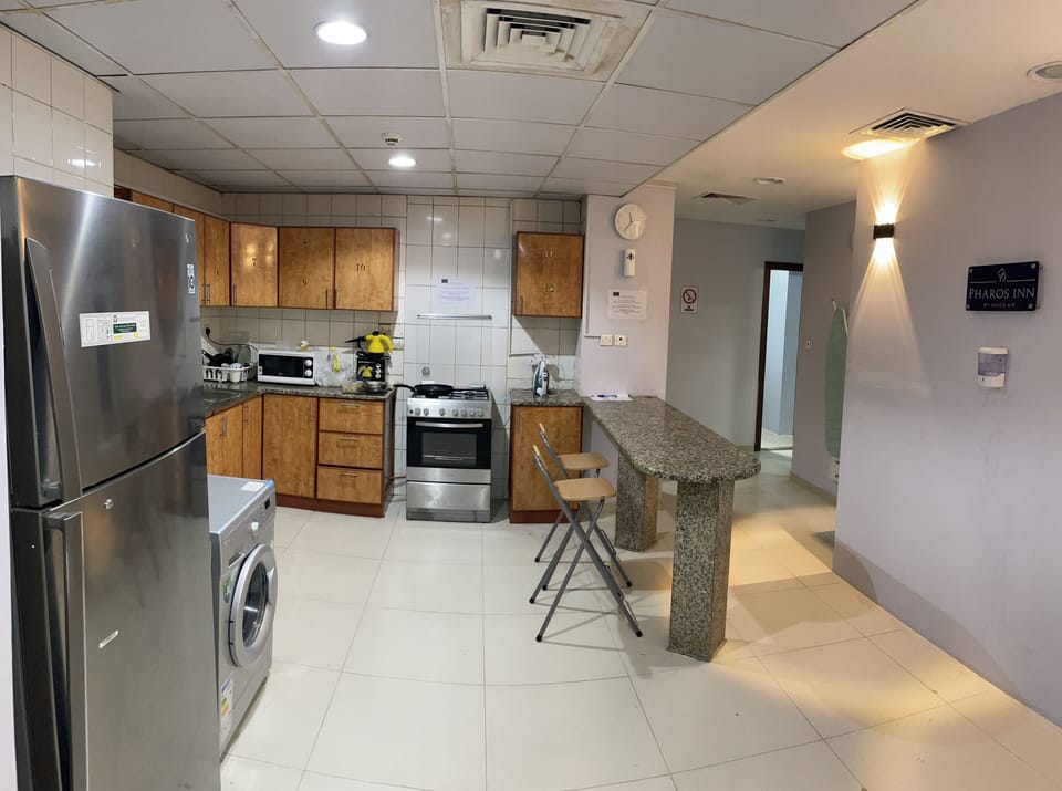 Full-size fridge, microwave, cookware/dishes/utensils, cleaning supplies