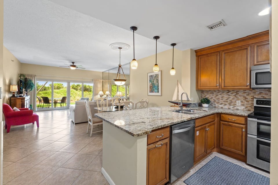 Kitchen features granite counters, a double sink, disposal, double oven/range, microwave, coffee pot, blender, toaster, and can opener.