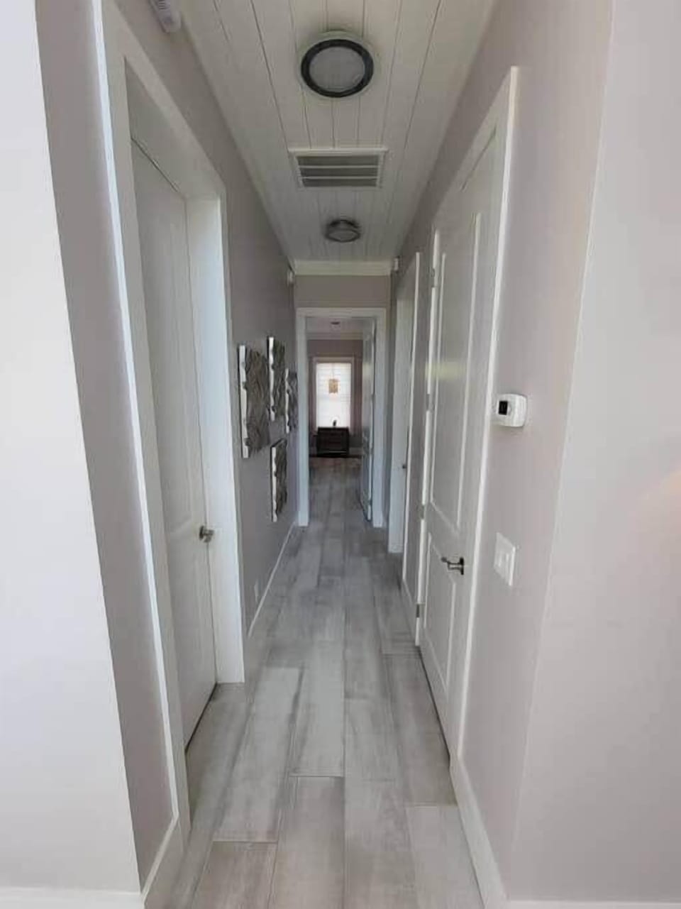 Hall way to master bedroom with private washer/dryer and half bath. 