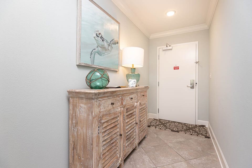 Step into a welcoming entrance featuring coastal decor that sets the tone for your beachside getaway