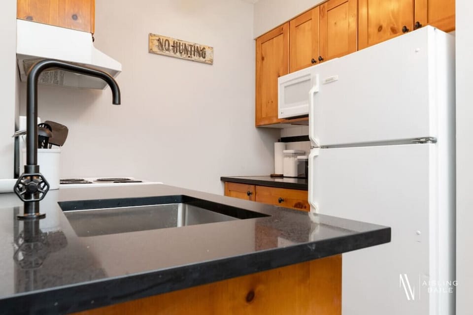Full kitchen with a drip coffee machine, ground coffee, tea and sugar.