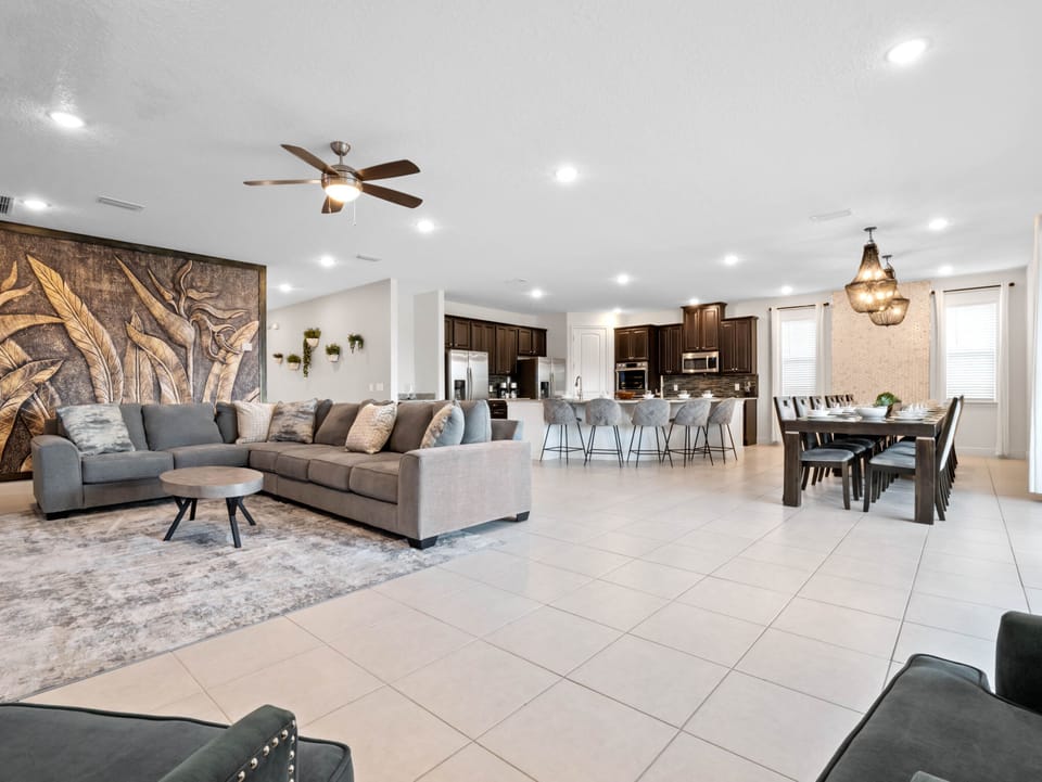 - Enjoy cozy evenings in this open living room with modern decor  
- Comfortable sectional seating perfect for family gatherings  
- Vacation rental near Disney with stylish family lounge