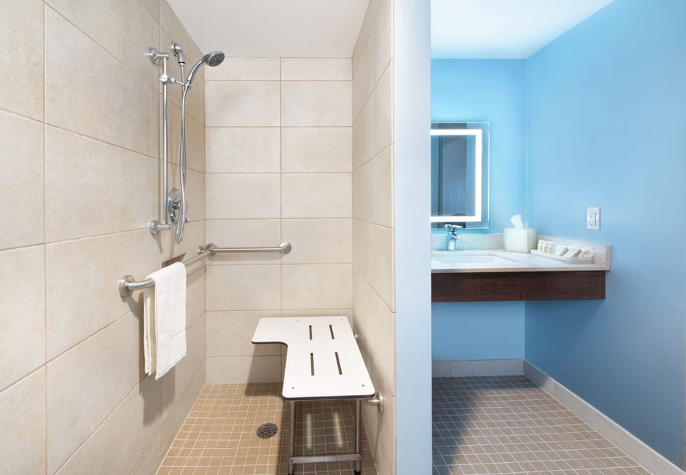 Suite, 1 King Bed, Accessible (Transfer Shower) | Bathroom | Shower, hydromassage showerhead, free toiletries, hair dryer