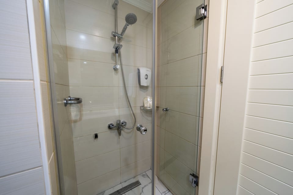 Shower, hair dryer, slippers, towels