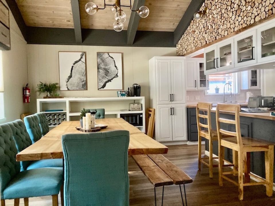 Big dining room with wood accents. Handmade dining table from a native tree