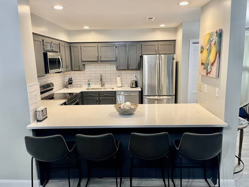 View of the brand new open floor plan kitchen. Kitchen countertop stools seat 4 and makes for a great gathering place to socialize while preparing meals.