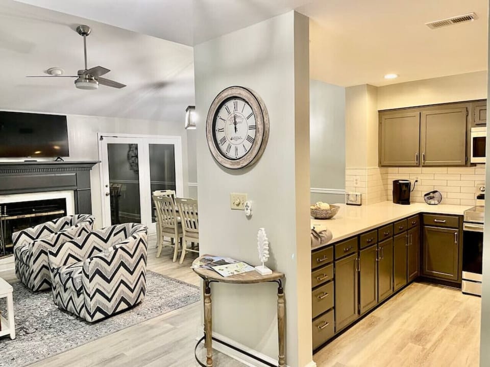 Photo of the open floor plan where the family room, dining table, and kitchen flow together.