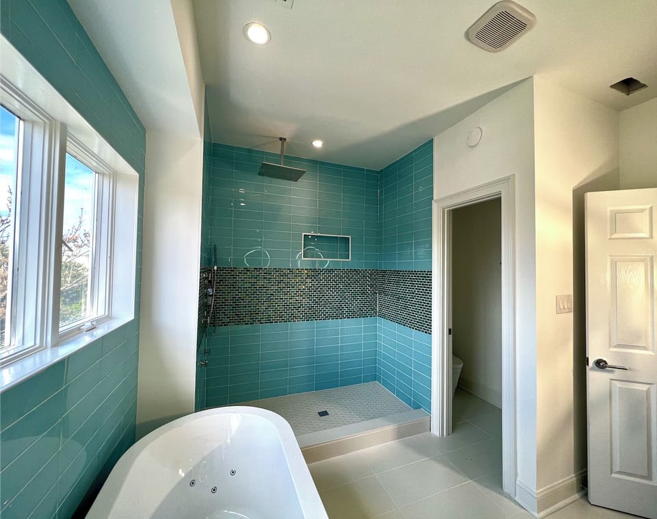 Glass tiled, walk in jetted shower and separate water closet
