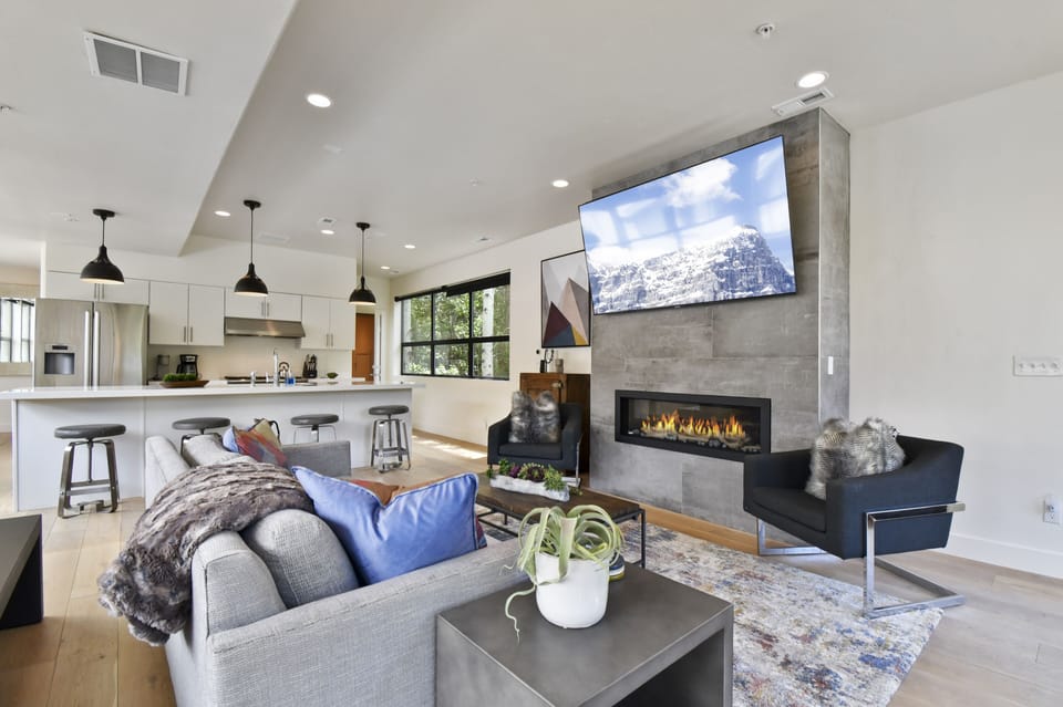 Hang-out space for everyone. Sofa for 3, chairs for  2,  barstools, and table. 