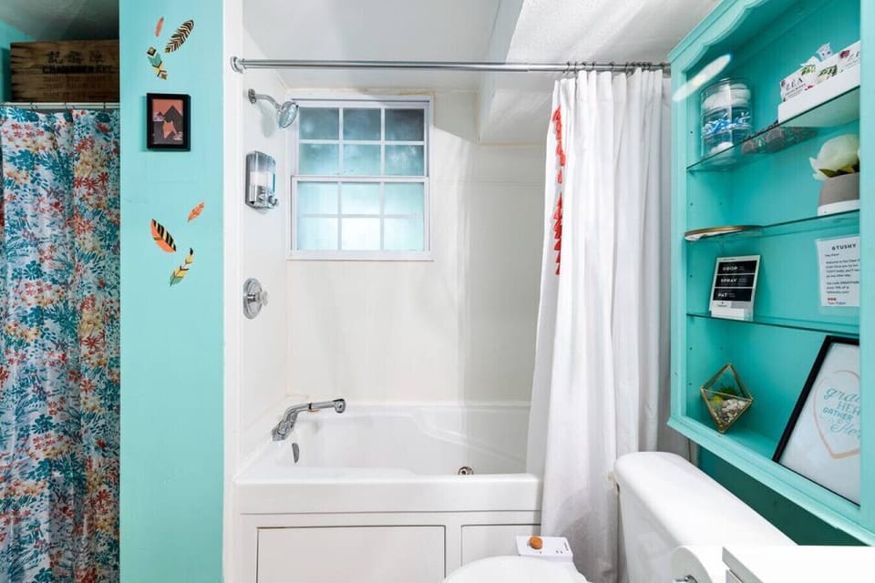 At the heart of the bathroom, a large shower and bathtub area awaits, offering versatile options for bathing and unwinding.