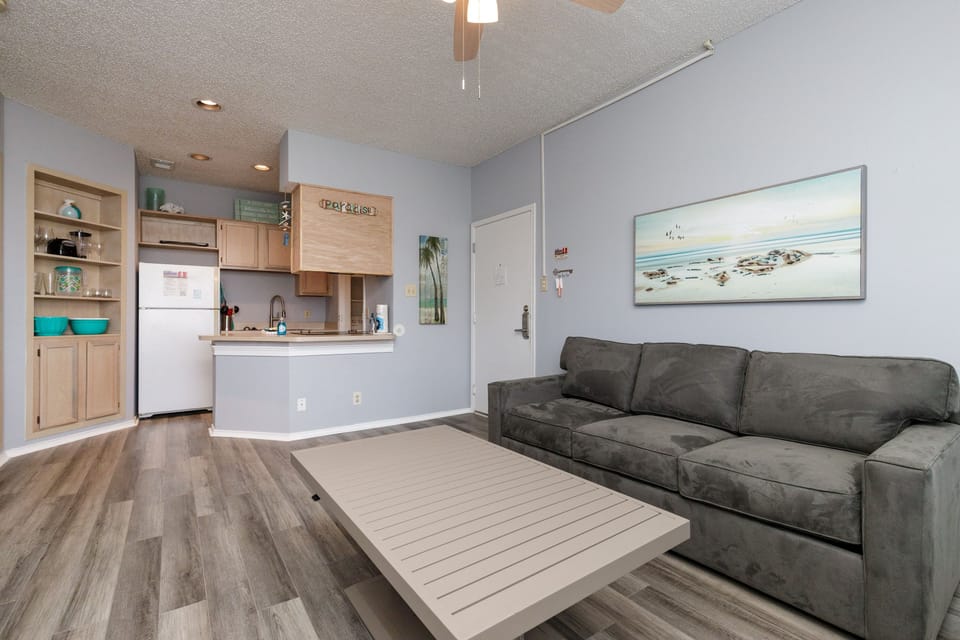 Unwind on your plush sofa while enjoying ocean views and the fully-equipped kitchen just steps away.