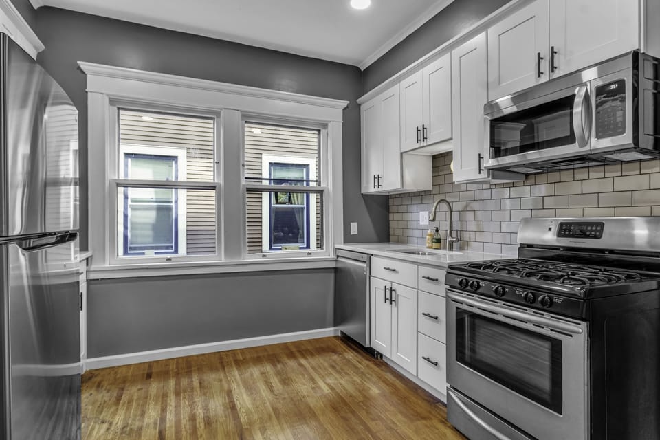 Kitchen with full size refrigerator, gas stove, oven and dishwasher.