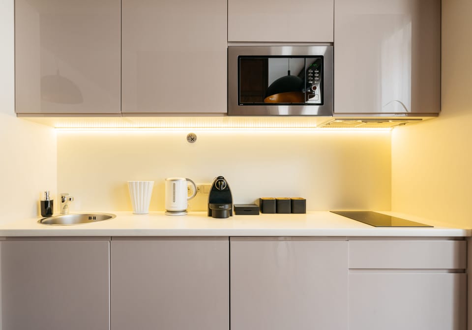 Executive Apartment, Balcony | Private kitchenette | Fridge, coffee/tea maker, electric kettle, paper towels