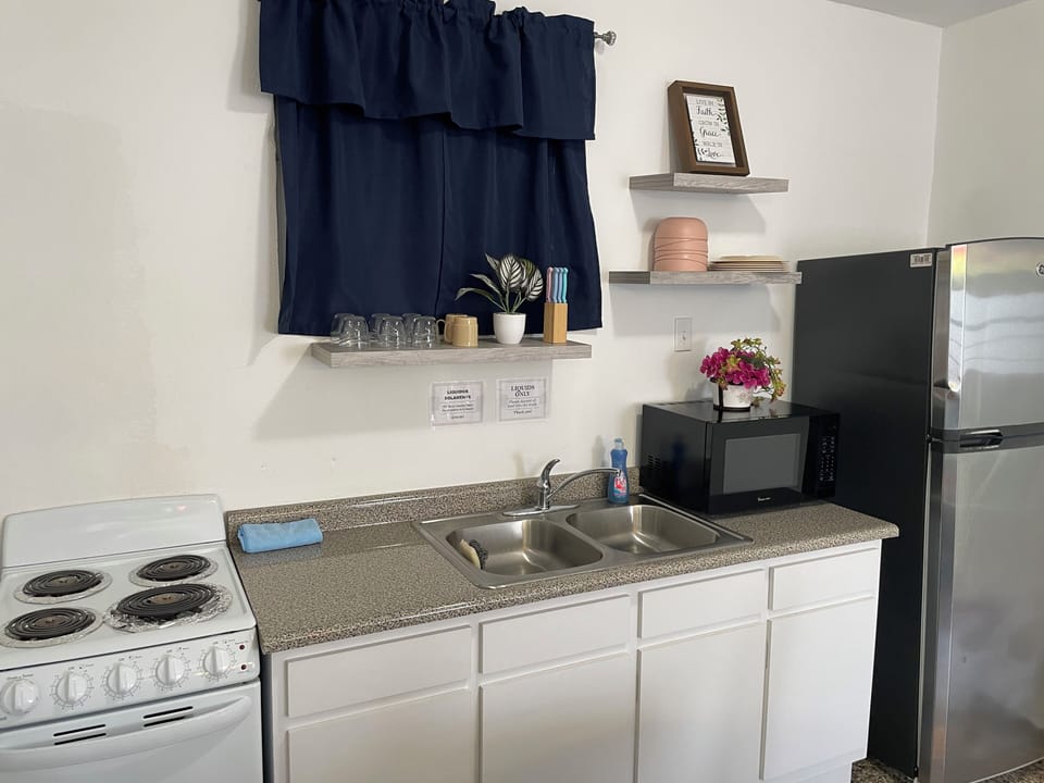Kitchen with microwave, refrigerator, electric stove
