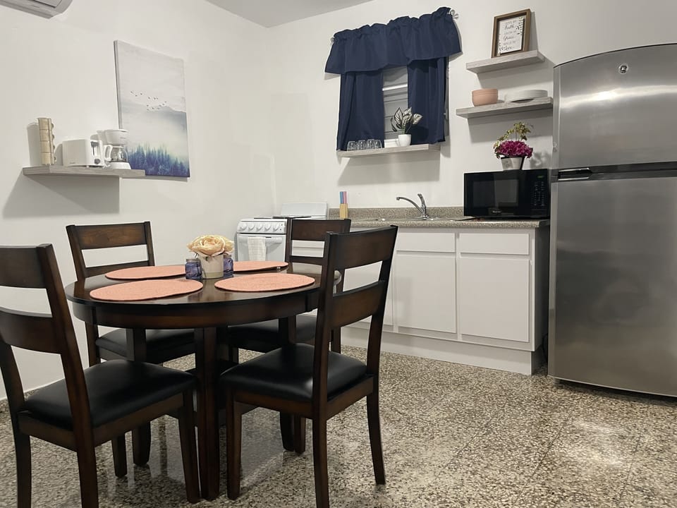 dining and kitchen with kitchen essentials and toaster, coffemaker, microwave