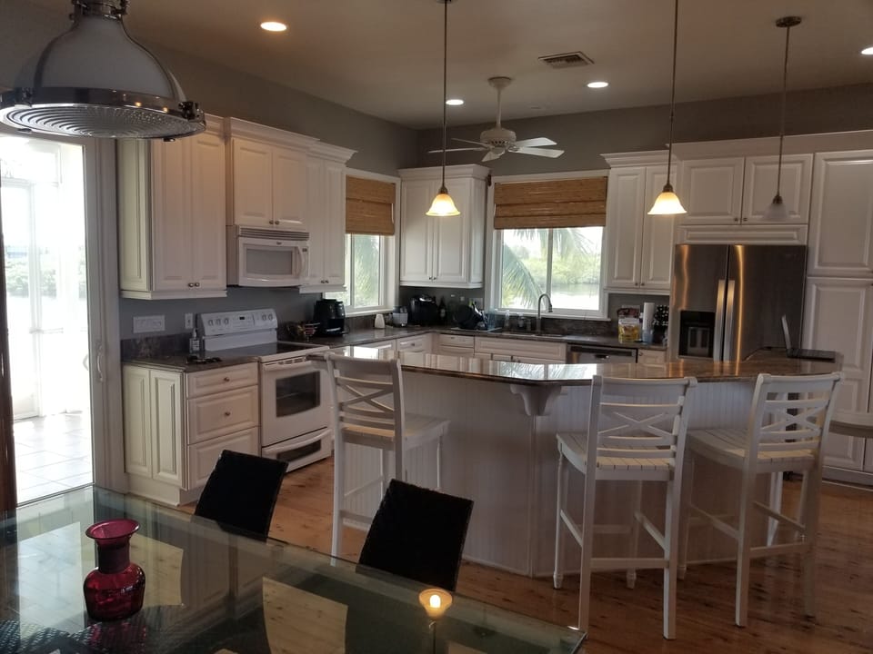 open kitchen with large two level island. air fryer, dishwasher