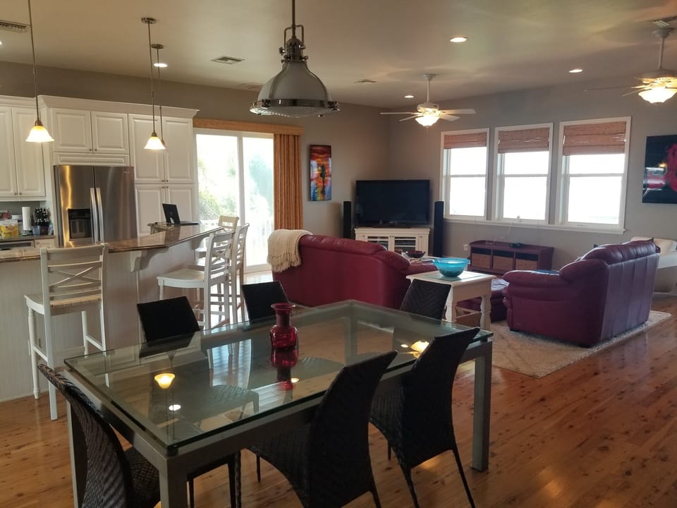 great room living area with bay view, tv, and sonos sound