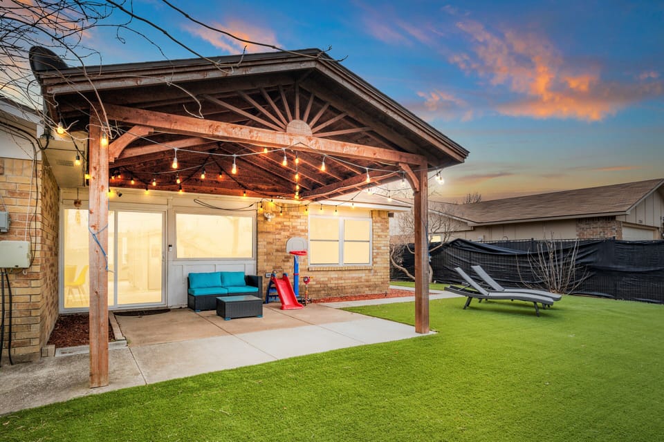 Nice patio space and backyard with lounge chairs, perfect for sunbathing