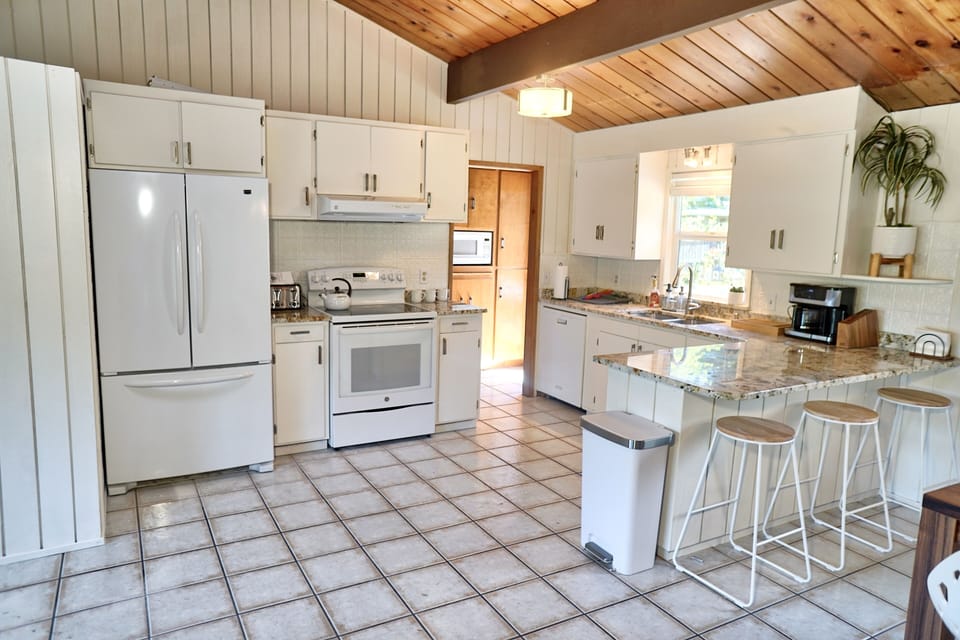 Well stocked kitchen with fridge, microwave, oven, toaster, coffee maker, etc. 
