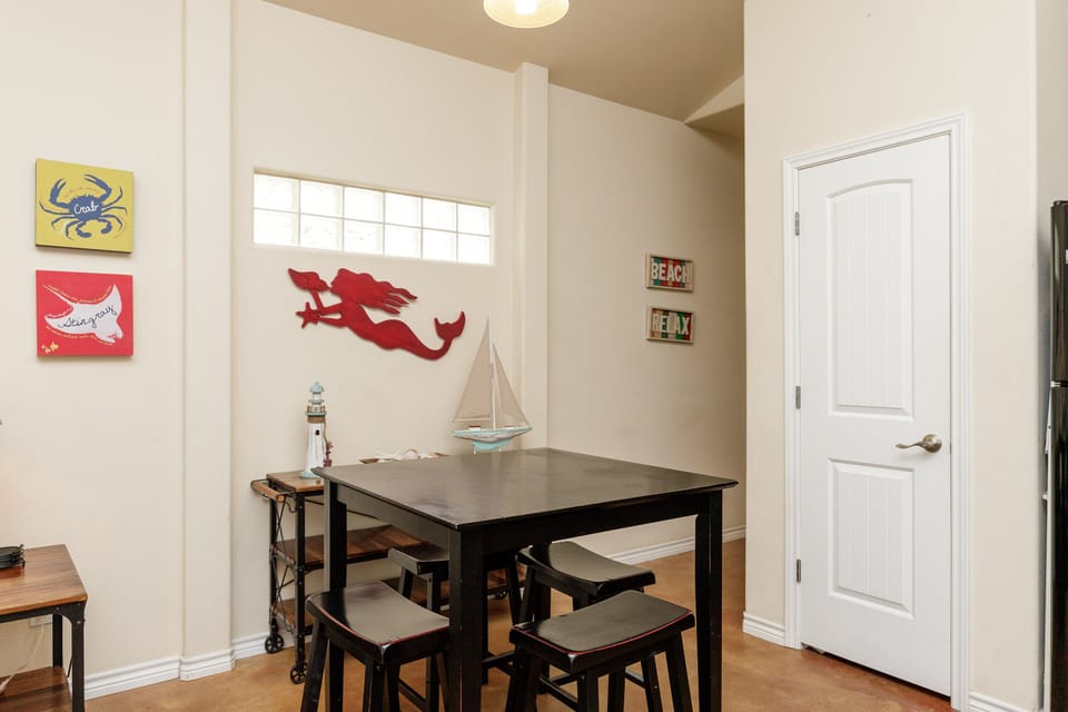 Gather around your charming dining table, surrounded by playful beach art and nautical touches that make every meal feel like a coastal escape.