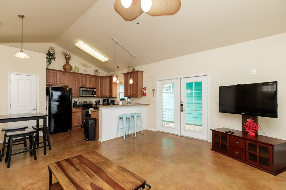 Relax in your open-concept living space with vaulted ceilings, complete kitchen, and entertainment area perfect for memorable evenings.