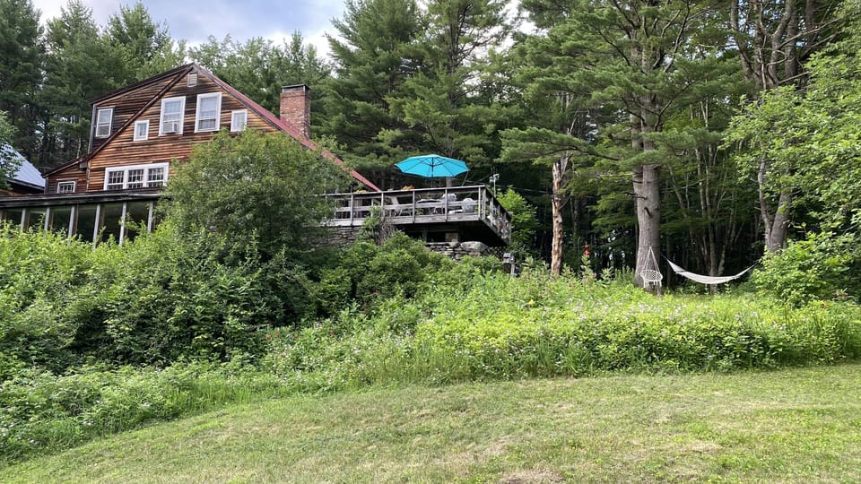 Deck overlooking garden and forest 