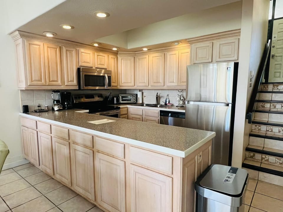 Stylish kitchen with modern appliances and large refrigerator.